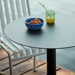 Palissade Cone Table Round By Hay -Finest Furniture Shop PalissadeChairskygrey PalissadeConeTableanthracite EnamelBowlspeckleblue TintTumblergreen